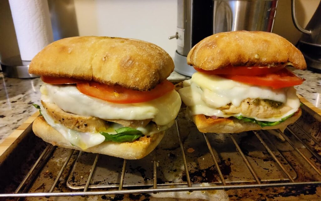 Grilled chicken sandwich with basil pesto sauce and mozzarella.