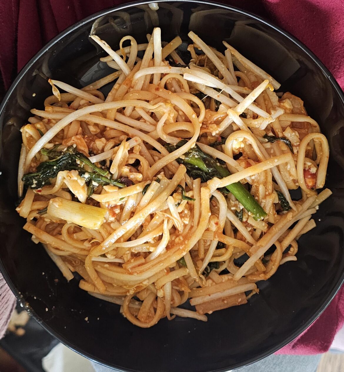 Bibimmyun using udon noodles with dandelion leaves, garlic scapes, bean sprouts, scallions and shredded soft tofu.