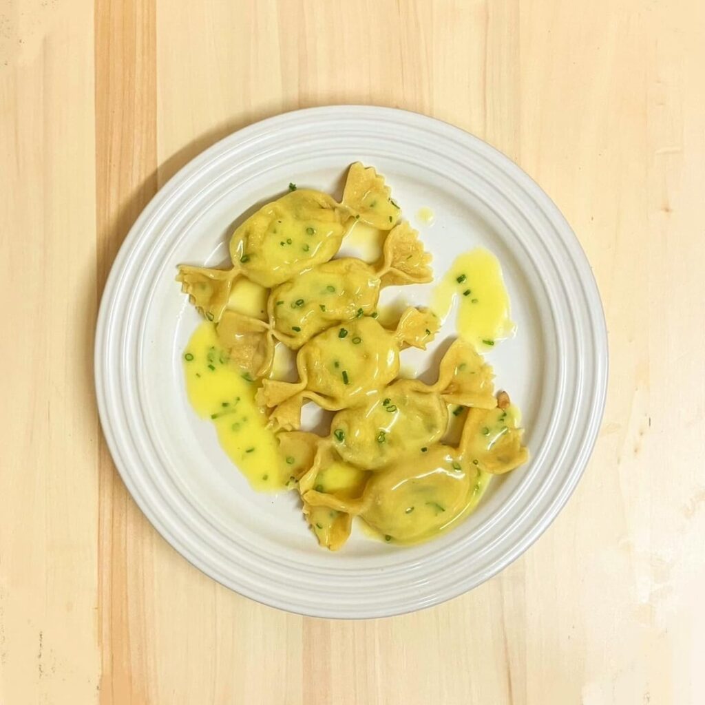 Caramelle filled with burrata, parmigiano reggiano and pesto in beurre monté 