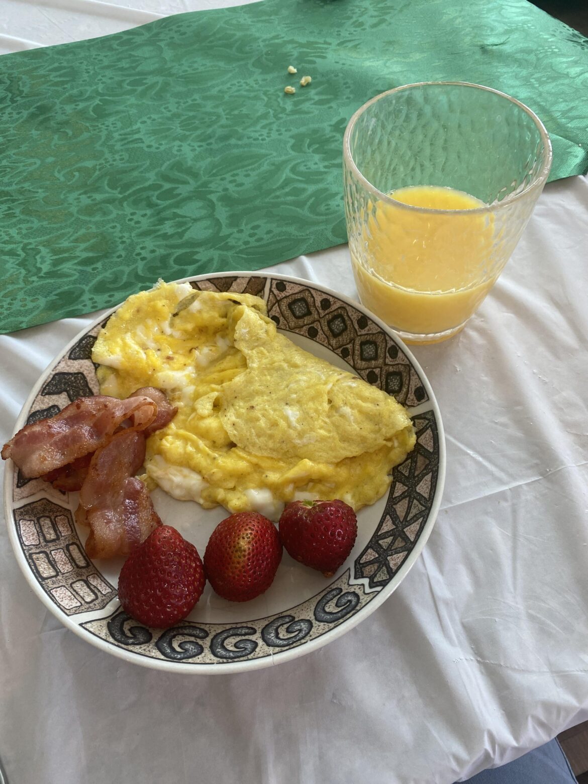 Scrambled eggs, bacon, strawberries