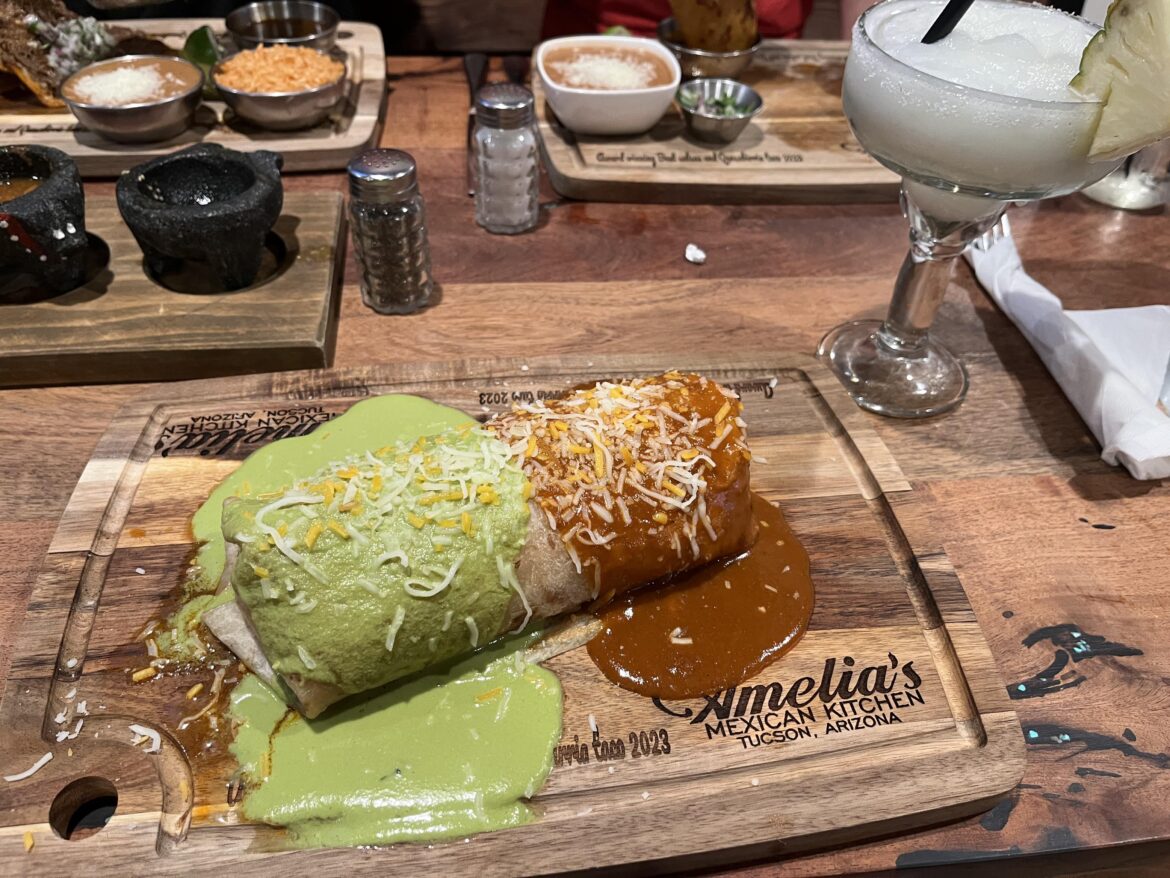 Birria and bean burrito filled with guacamole and sour cream, double enchilada style.