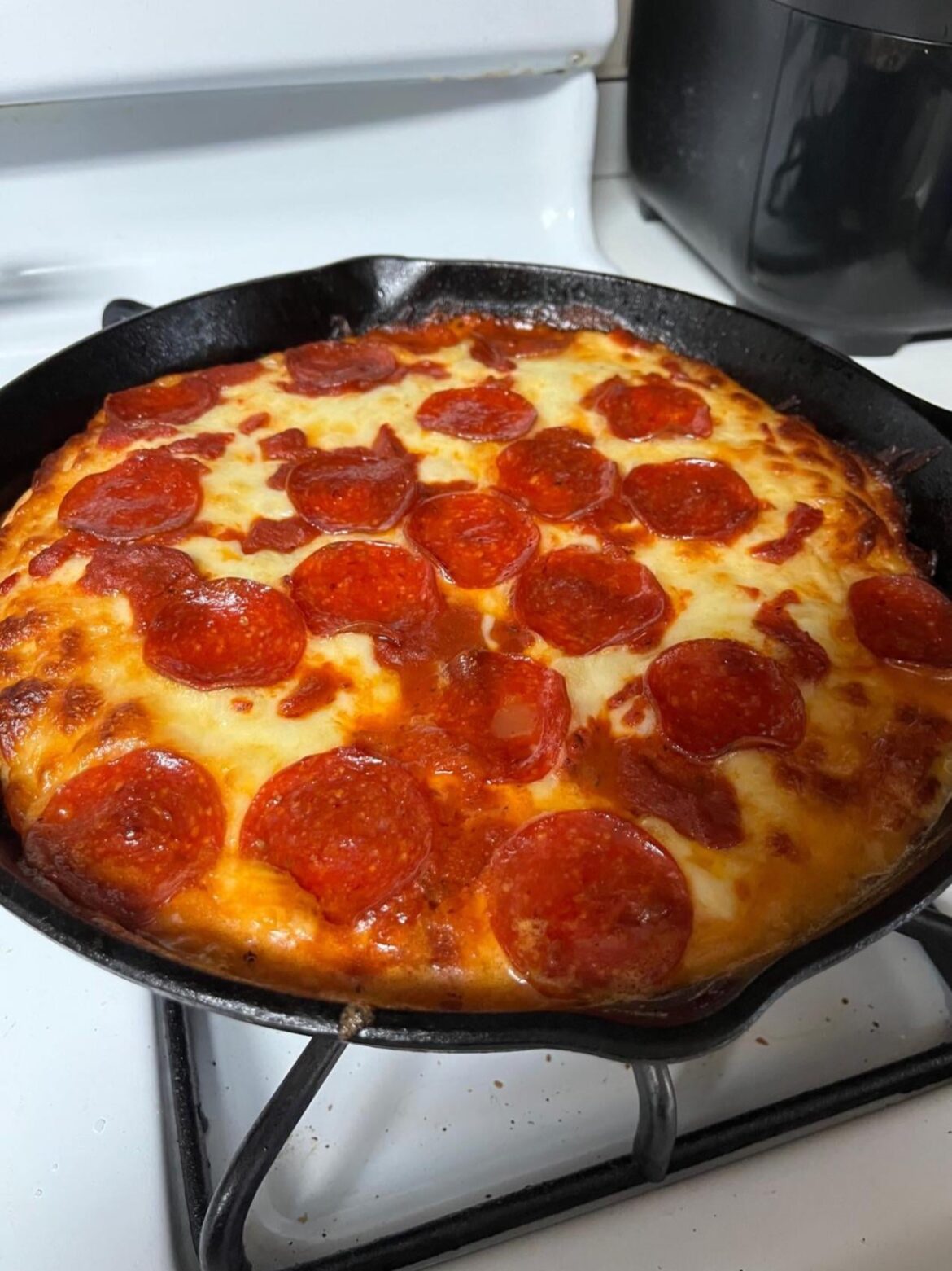 Pepperoni/cheese deep dish pizza in a cast iron skillet.  The cast iron makes such a chewy, crunchy perfect crust.