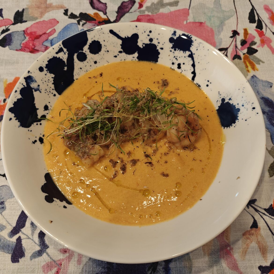 Miso-marinated monkfish over carrot-lobster bisque with microgreens and grated truffles
