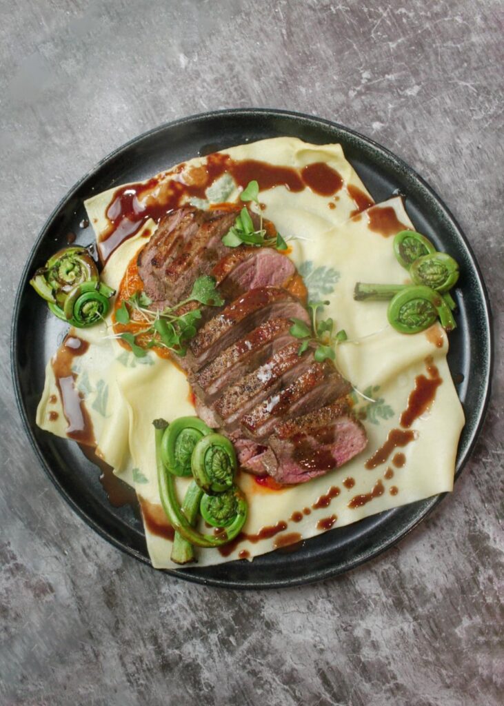 Main Course: Freshly rolled & herb laminated pasta plates, duck breast, passata sauce, fiddleheads & and red-wine reduction butter sauce / Dessert: Naval orange sorbet with a wild berry coulis served in an orange peel cup