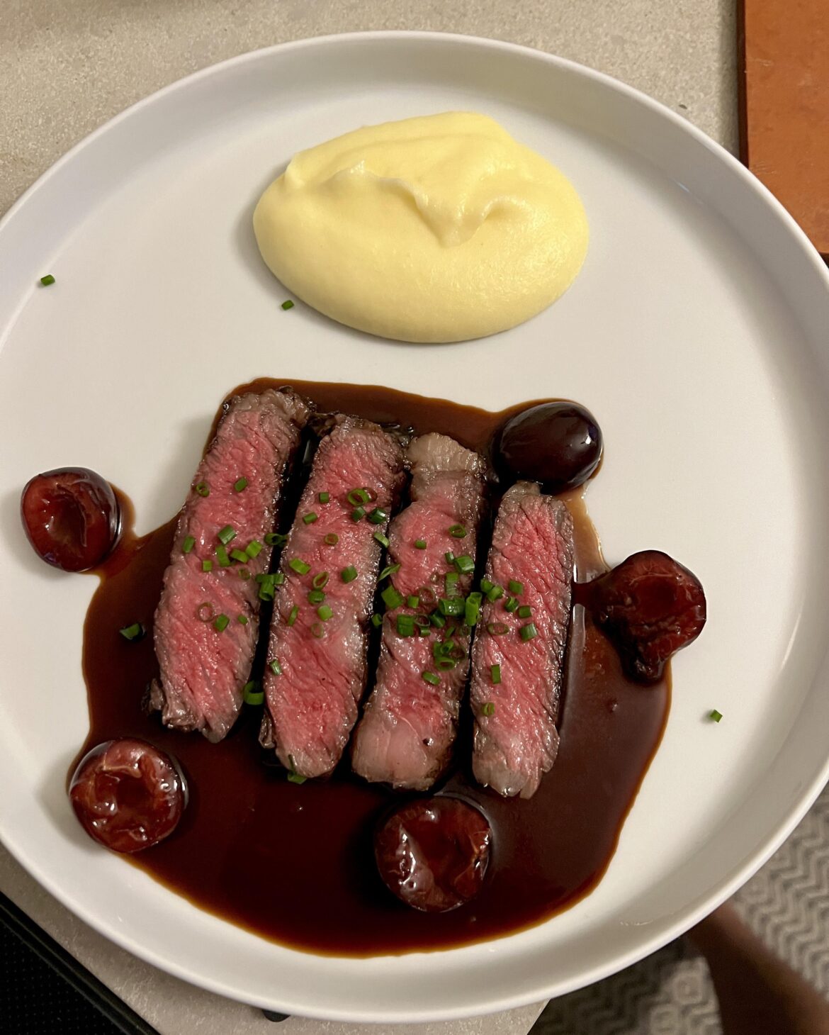 Australian wagyu ribeye, cherry balsamic sauce, pommes purée a la Robuchon