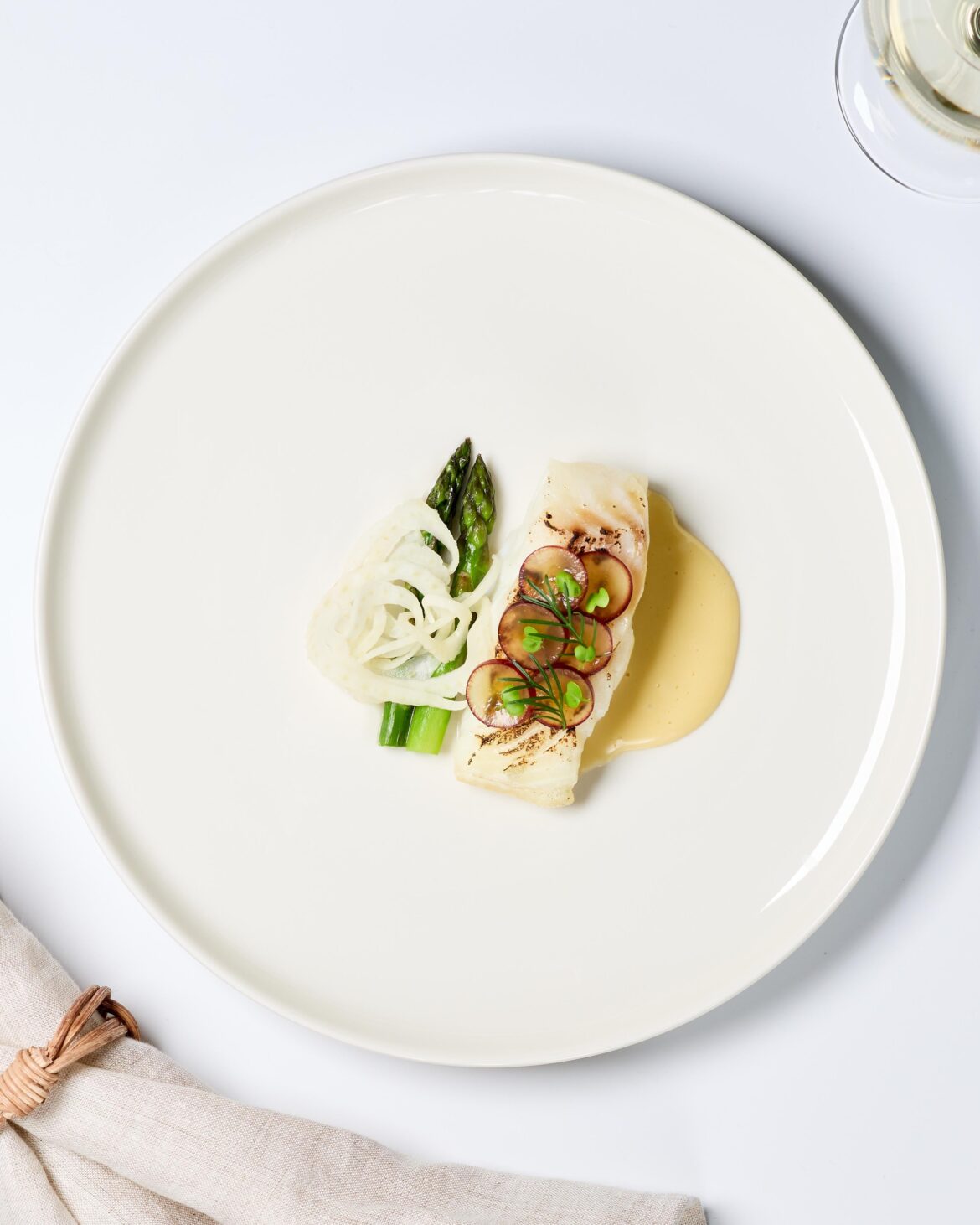 Cod with hollandaise, butter poached asparagus, fennel pickled in rise vinegar and grapes