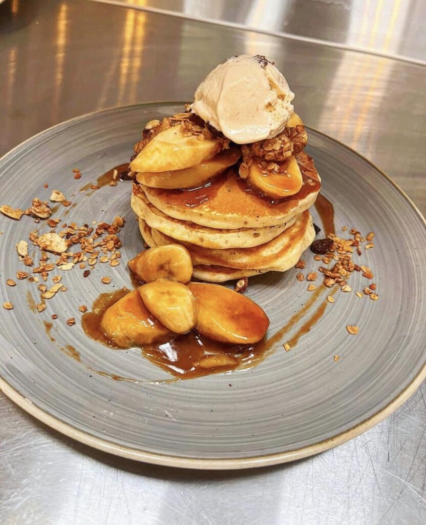 Buttermilk pancakes, toffee sauce, caramelised banana, rum & raisin ice cream, caramel granola & chewy banana