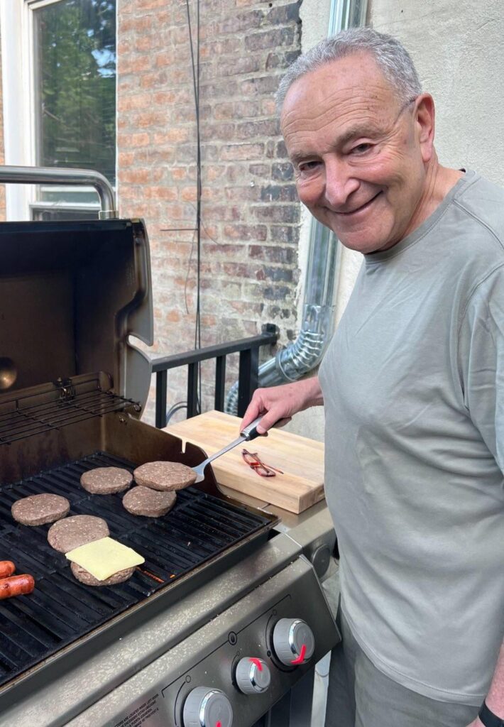 Chuck Schumer attempts to grill a cheeseburger