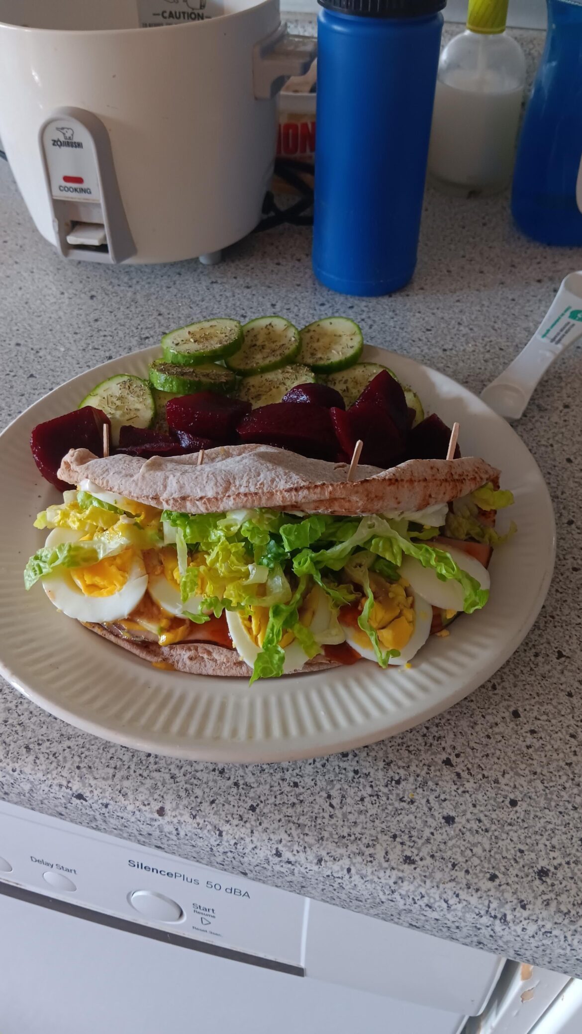 Egg, ham, pita.cream cheese and mustard sandwich