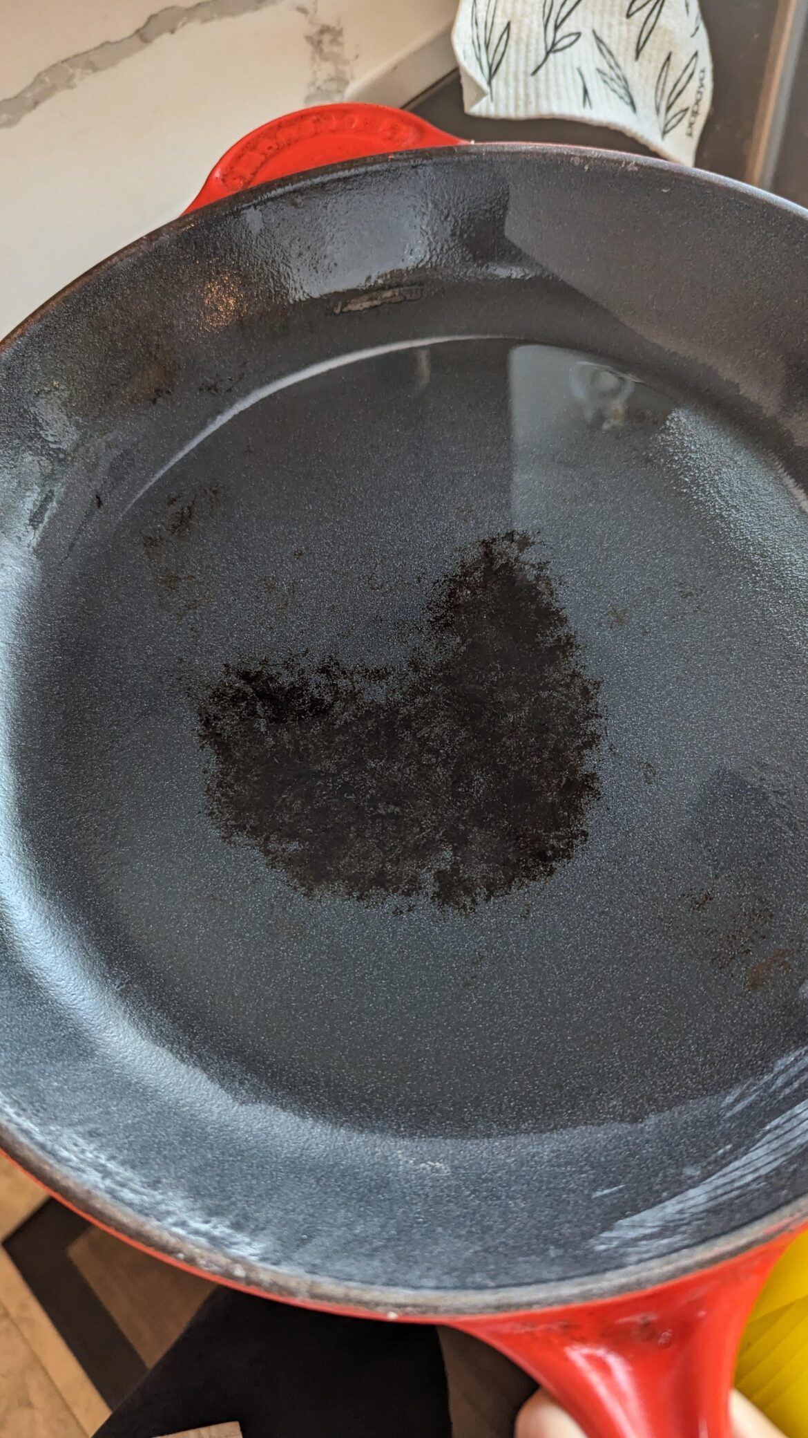 Tried parchment paper cooking on my enamelized cast iron. It made for delicious fish but there's a spot I can't remove! Help?