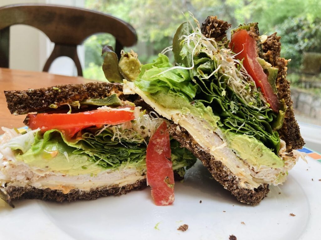 Dark Rye, peppercorn turkey; cream cheese, chipotle mayo, tomatoes, lettuce, sprouts, avocado, charred peppers, havarti.