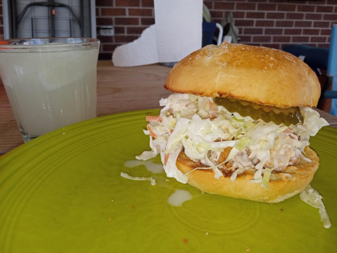 BBQ Chicken Salad with Cole slaw and dill chips on lightly toasted Telera roll.