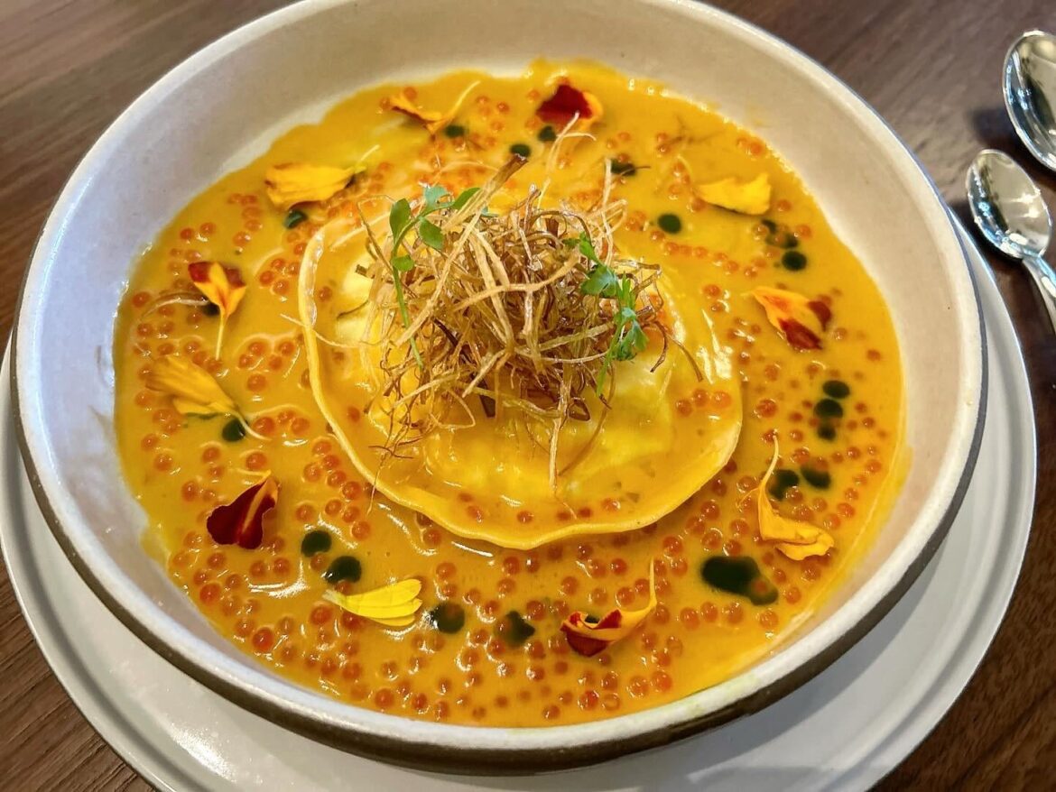 Soy cured Egg yolk Raviolo, Uni butter, Fried Leeks, Trout Roe, Shiso oil