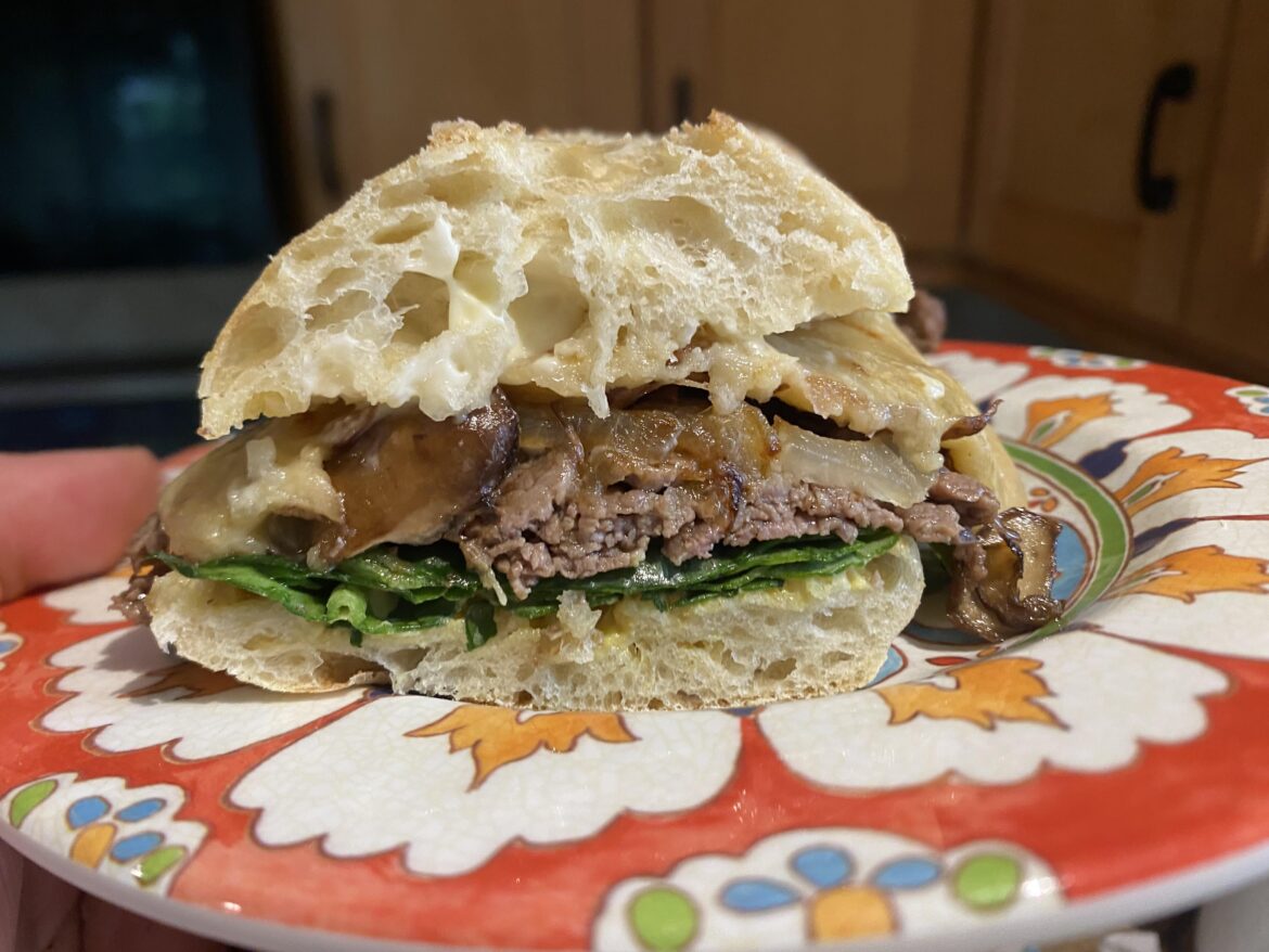 Lunch: steak, onion, mushroom, spinach, cheddar with caramelized onions, Dijon, mayonnaise, on a ciabatta roll