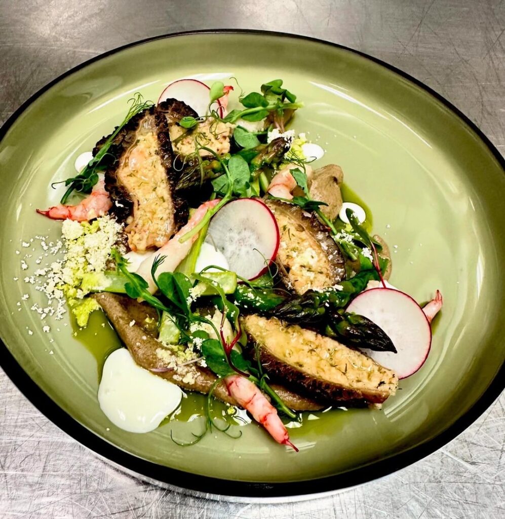 Stuffed morels with spot prawn mousse, morel purée, creme fraiche, olive oil powder, micro pea shoots