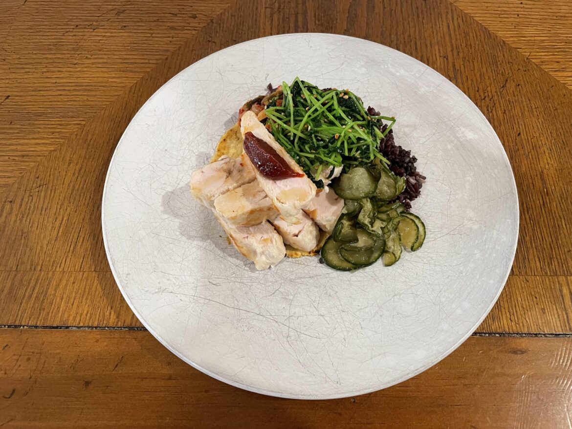 Chicken over Korean rice and tortilla with banchan