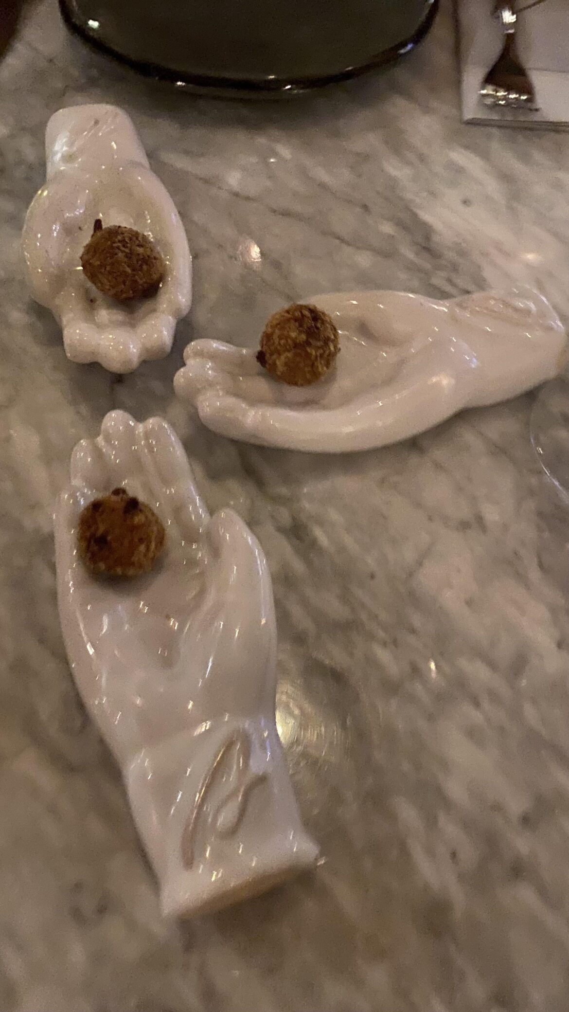 Each hand serves a single fried croquette.