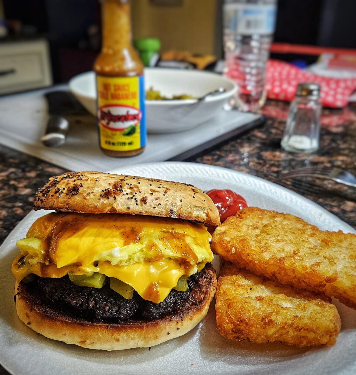 Sausage, egg, cheese, and green chile on an everything bagel.