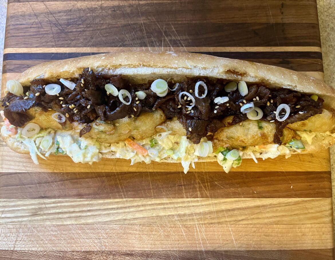 Teriyaki beef and spicy kakiage (tempura fish cake) on wasabi slaw