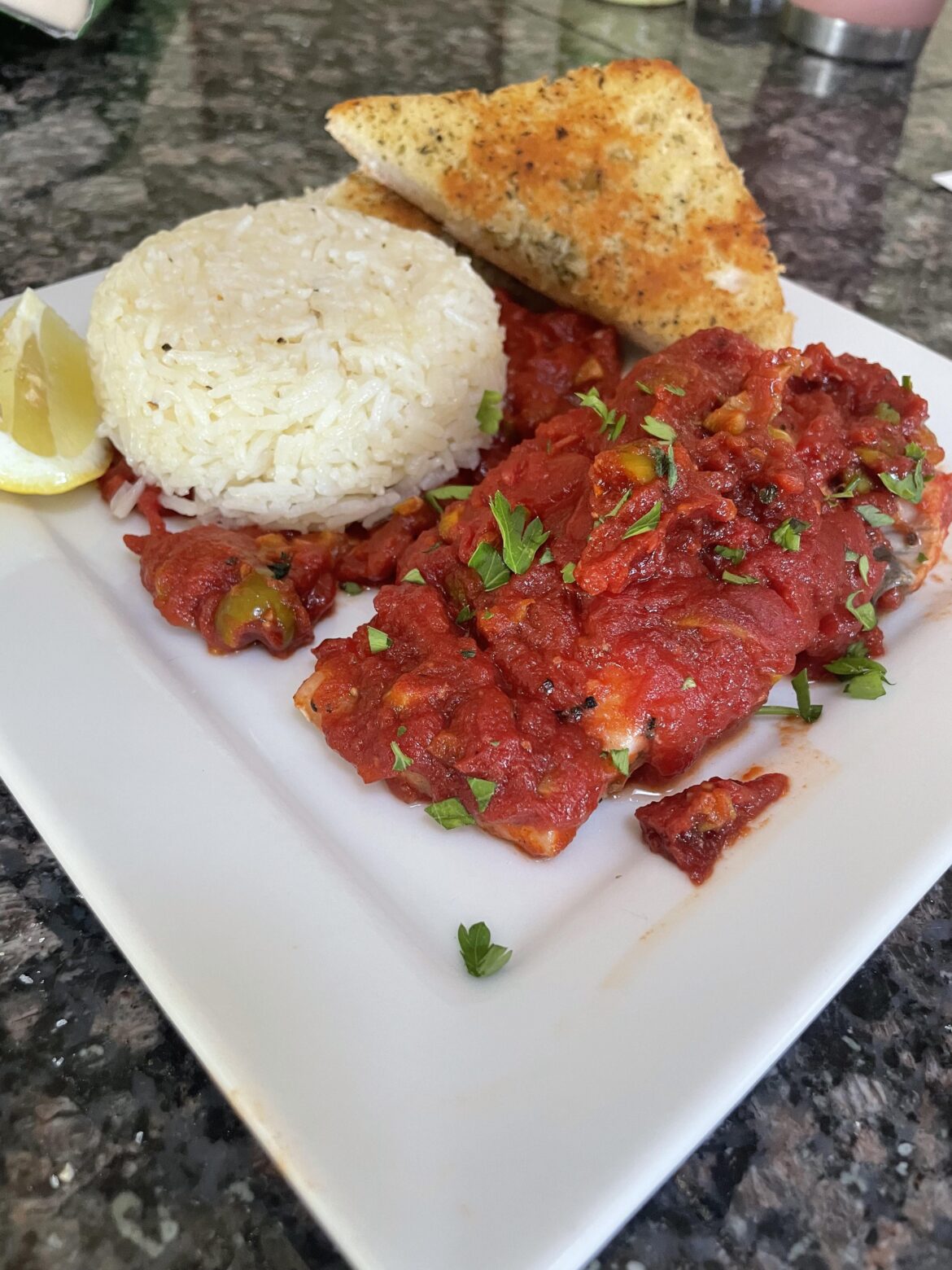 Abruzzo-style roasted tomato barramundi . Super delicious and easy . Starving so I added some jasmine rice.