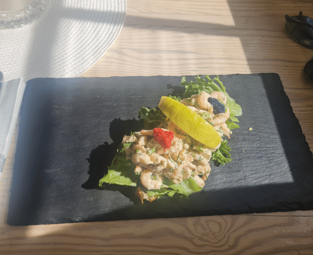 Shrimp sandwich or something served on a stone slab