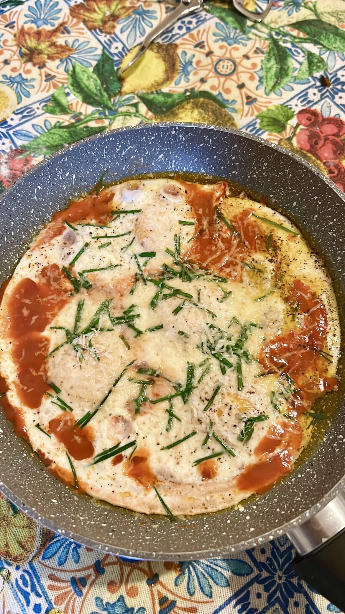 Eggs with tomato sauce, parmigiano and green onion