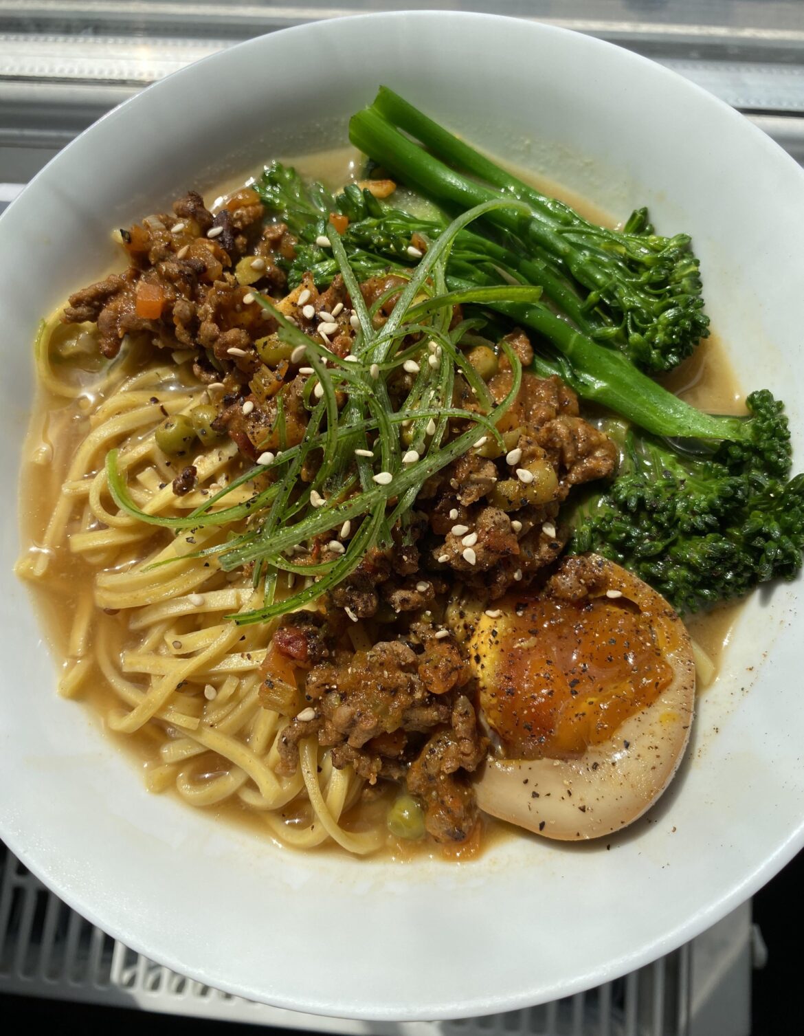 Daniel daniel noodles with a soy egg on top