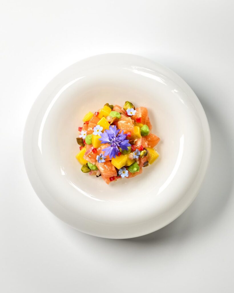 Salmon tartare with mango, yuzu, pistachios, chili, shallots and avocado cream.