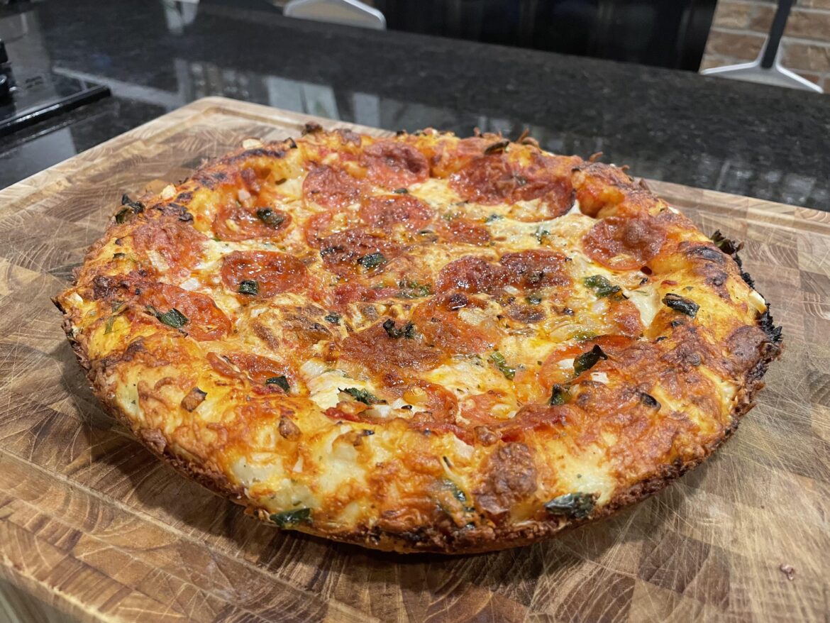 Cast iron style stuffed crust pizza with pepperoni, onion, and a home grown jalapeño.