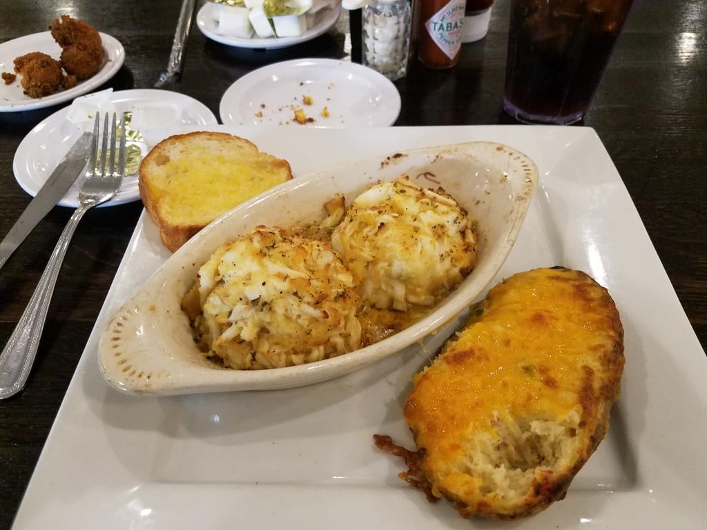 2 Lump blue crab cakes, stuffed potato, garlic bread, hush puppies and 1 coke Dining and Cooking