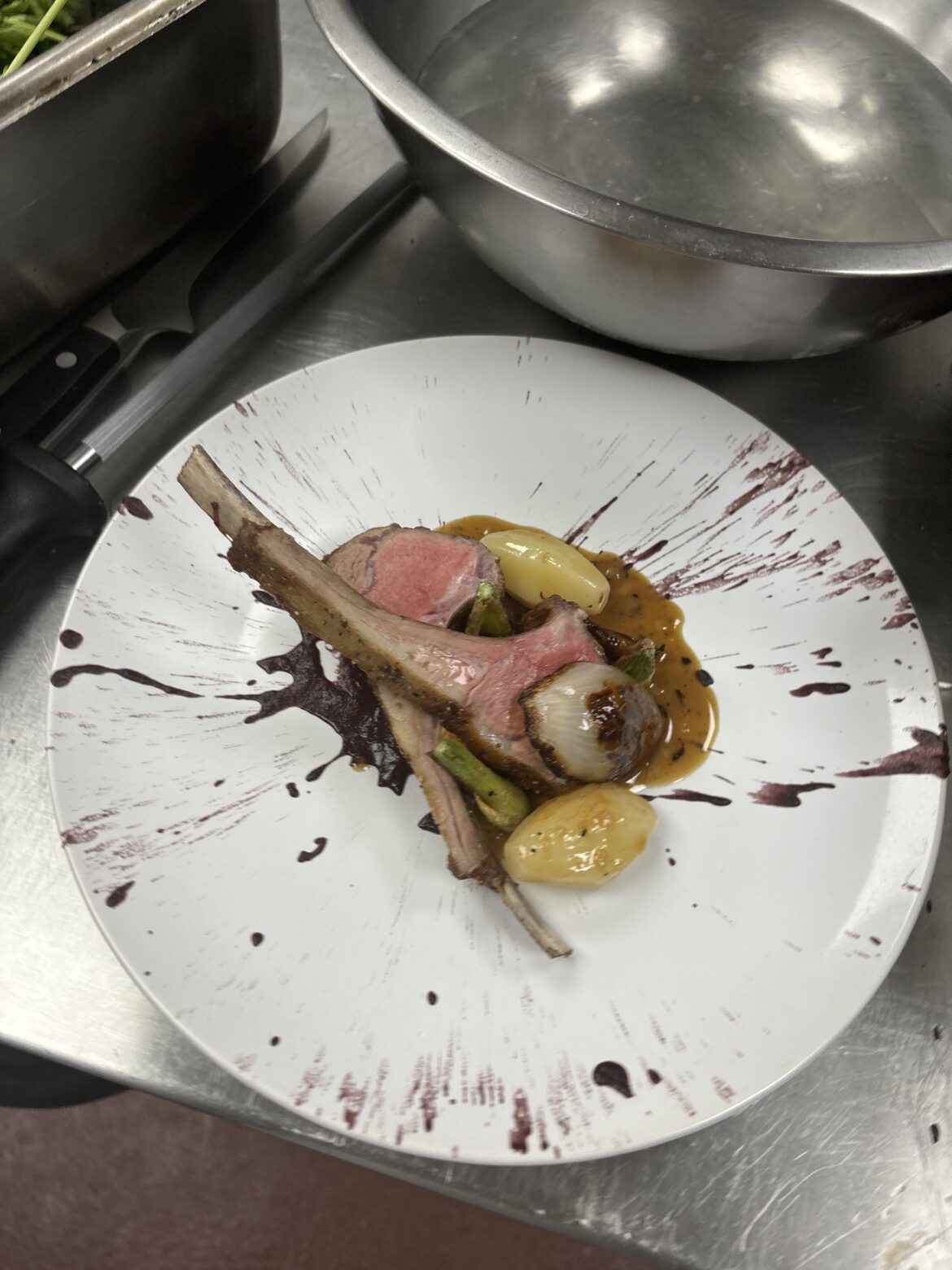 Rack of lamb with a black olive puree glazed potato tourne’s glazed fennel caramelized shallot and a pan sauce