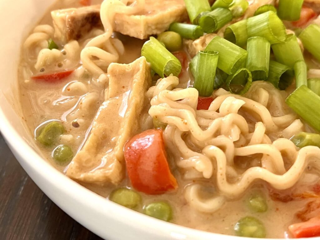 Ramen noodles with tofu and vegetables in peanut-butter and soy sauce broth.