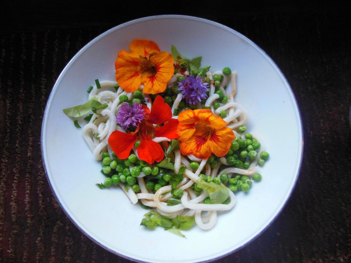 edible nasturtium blossoms are a fun way to make a dish look extra fancy. some of them have a slight peppery kick. so pretty in salads. the purple ones are chive blossoms.