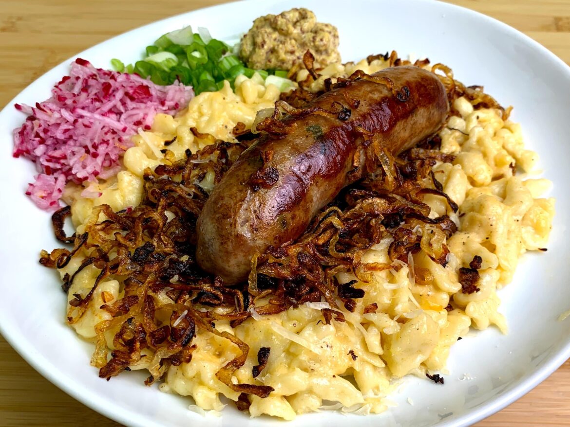 Homemade Wurst on Kaesespaetzle and Caramelized Onions