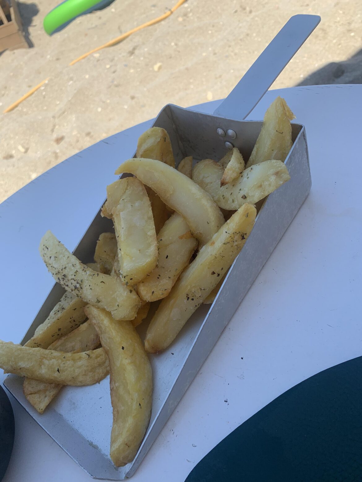 The forgot to pour the chips onto the plate and left them in the scoop
