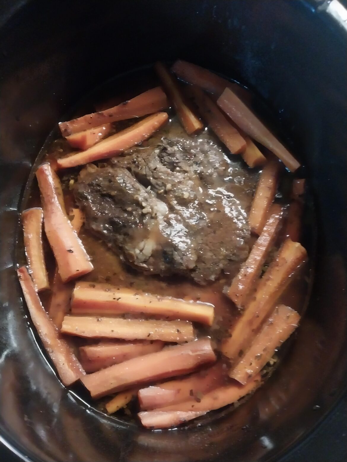 Slow and low for 6.5 hours. 2.5 lbs of chuck steak, some gravy some spices, hot sauce, and a bunch of carrots.