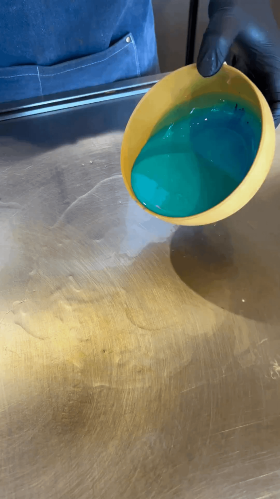 A fluffy egg omelette covered with demi-glace and served upside down over fried rice is called an omeurice. It's dubbed the hardest omelette in the world to prepare. This is an exquisite blue rendition.