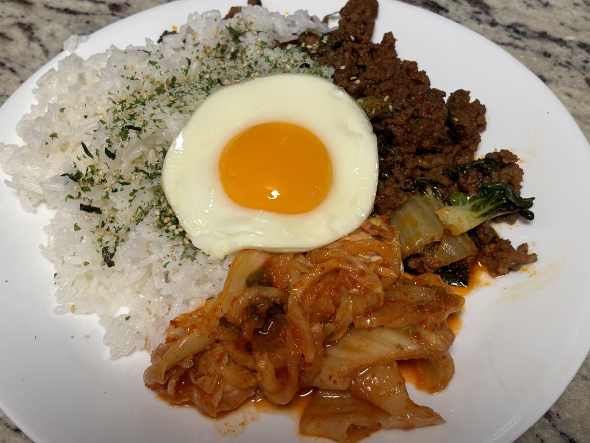 Spicy korean ground beef with baby bok choy, kimchi, rice with furikake topped w/ an egg. This pic was taken before I mixed it all together, so good 🔥