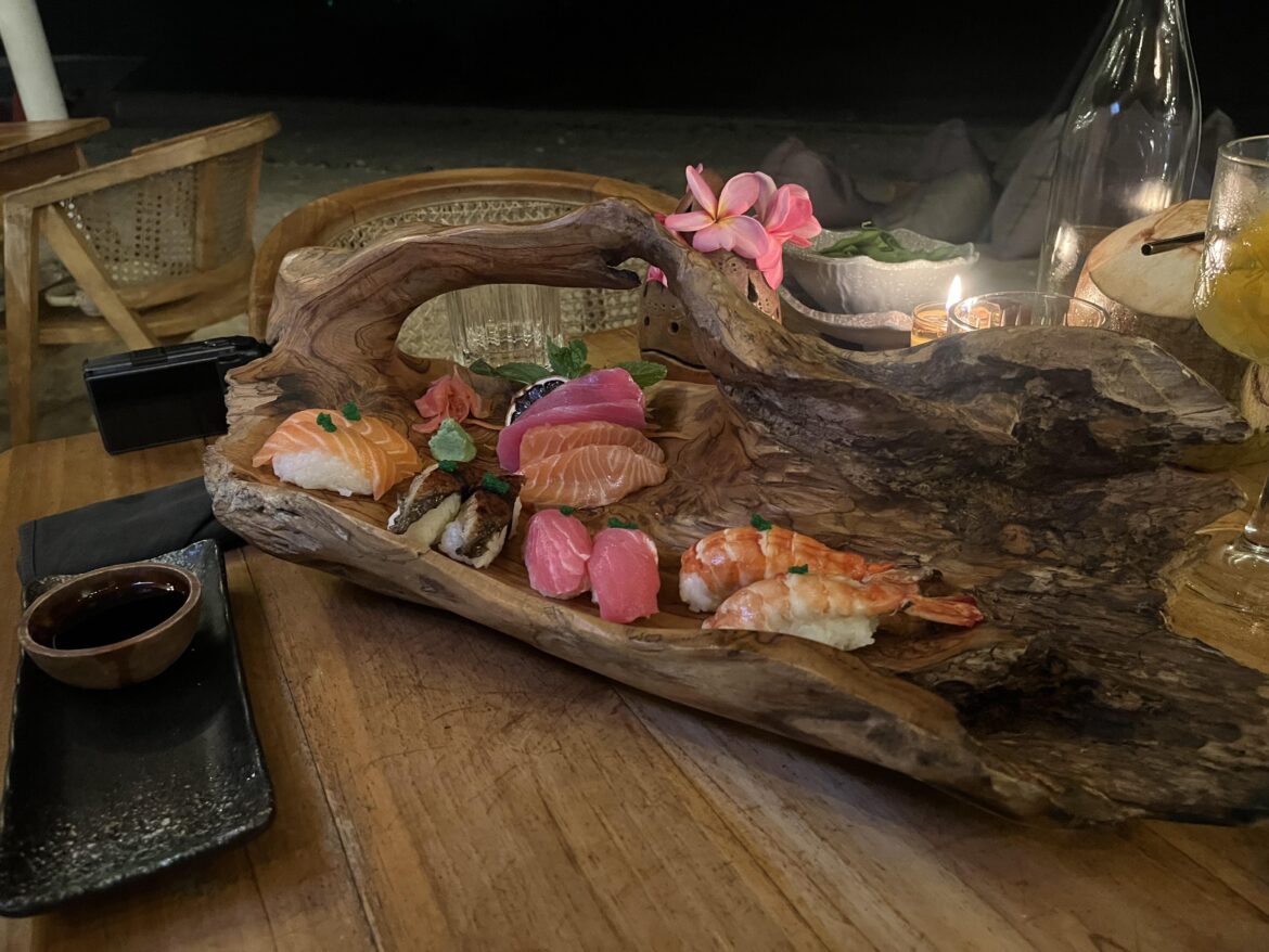 Sushi served on a giant piece of driftwood, complete with its own handle