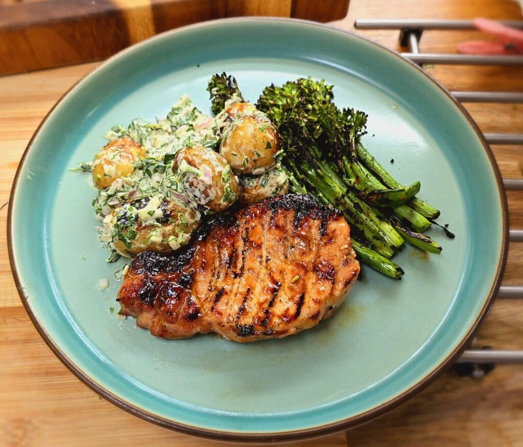 First cook: Spicy maple glazed pork chops, smoked potato salad, and grilled broccolini