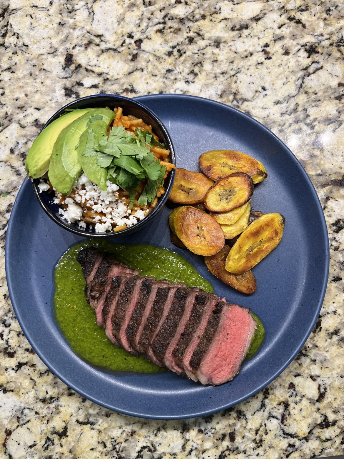 Grilled ribeye with chimichurri, fideo seco, and plátanos