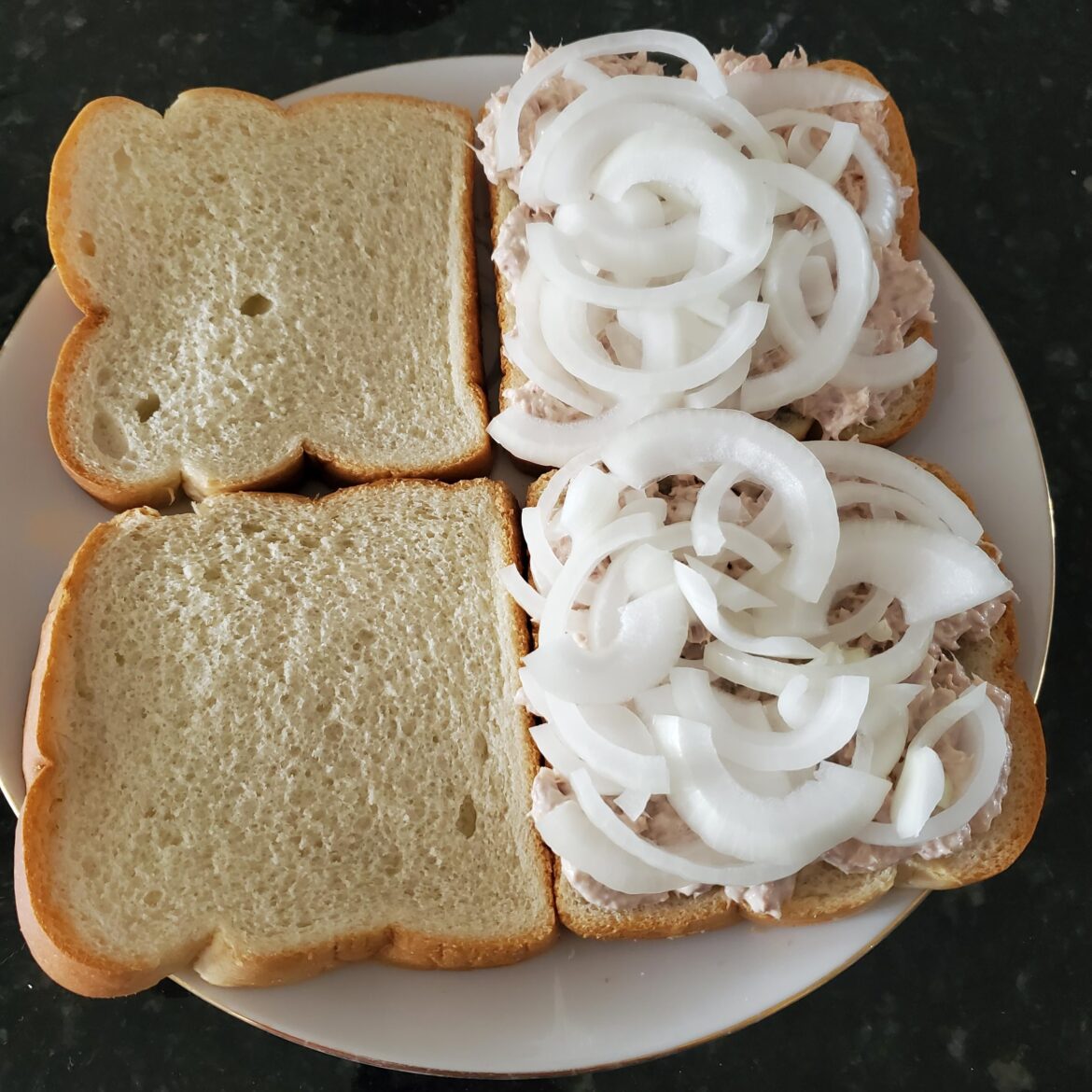 A touch of onion on some tuna sandwiches.