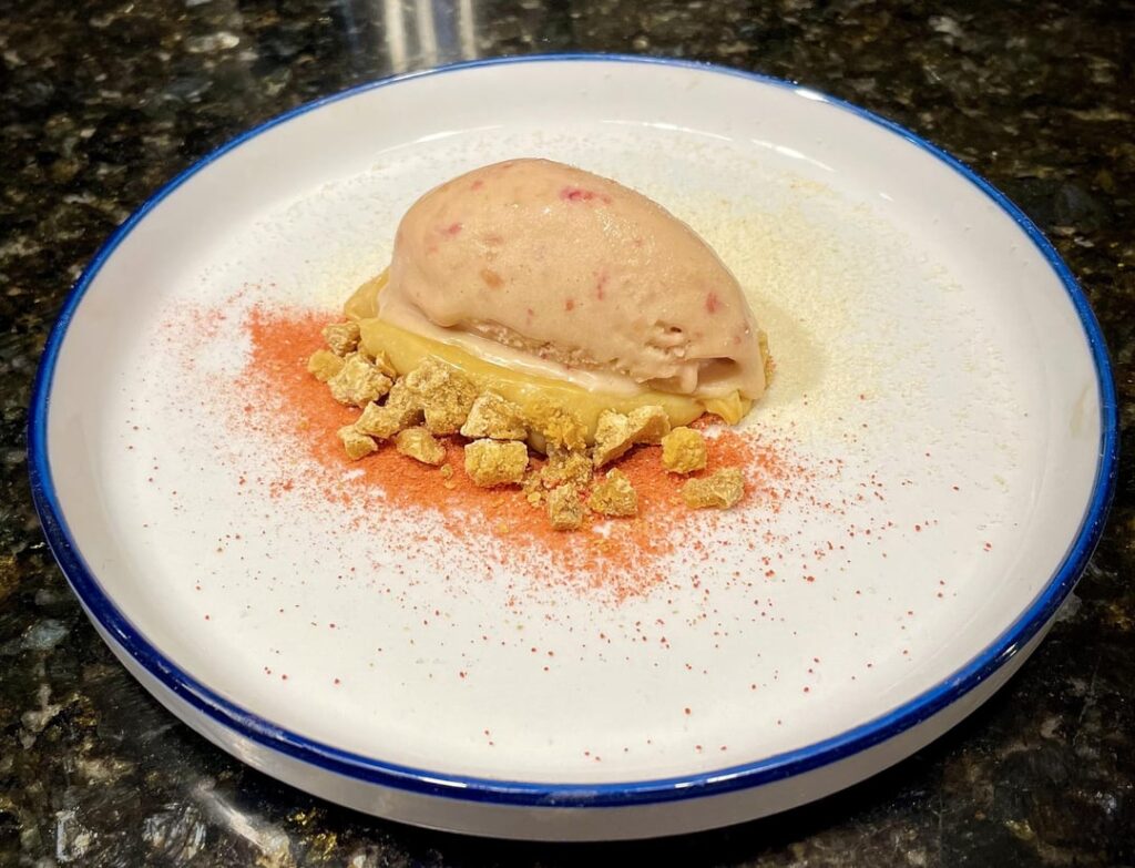caramelized white chocolate raspberry ice cream, meringue powder, strawberry powder, caramelized white chocolate crumble and ganache