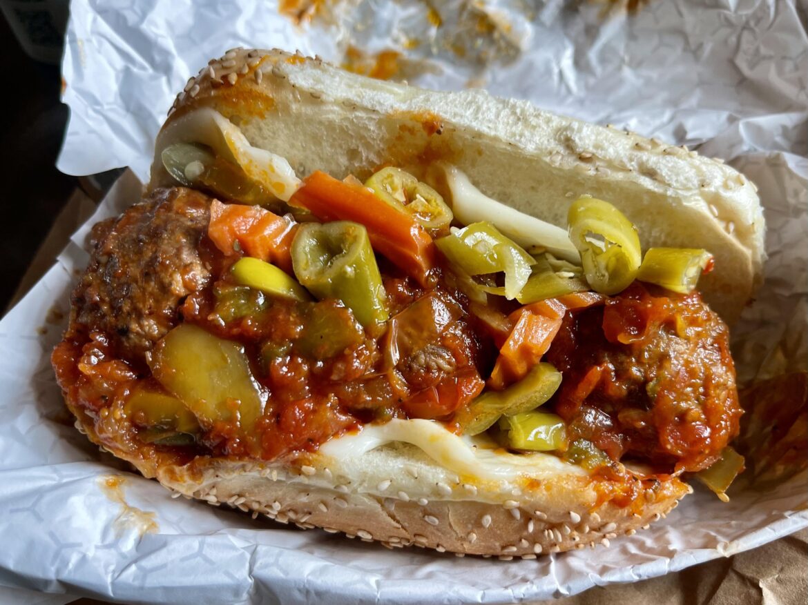 Meatball sandwich with provolone, red sauce, onions, peppers, and hot giardiniera. Pass the napkins.