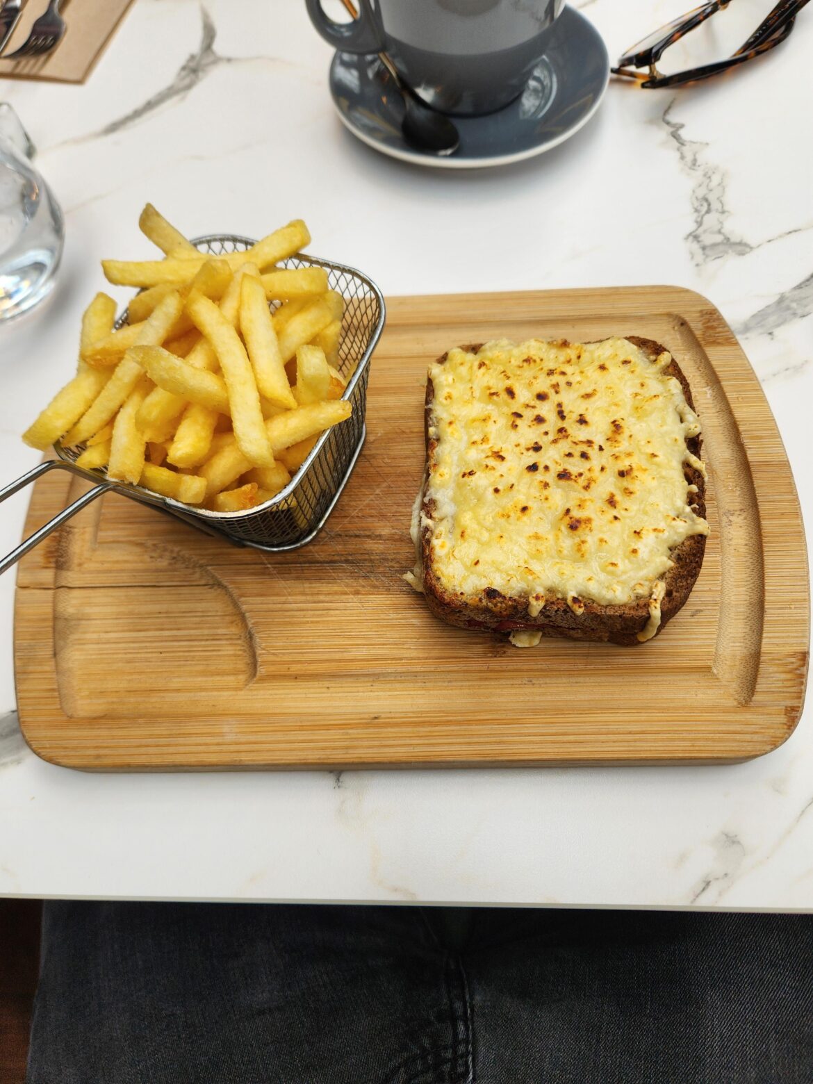 My first Croque Monsieur in Paris and it's on a cutting board.