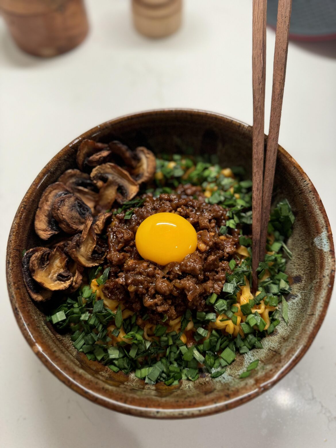 Egg yolk ramen with spicy beef and garlic chives