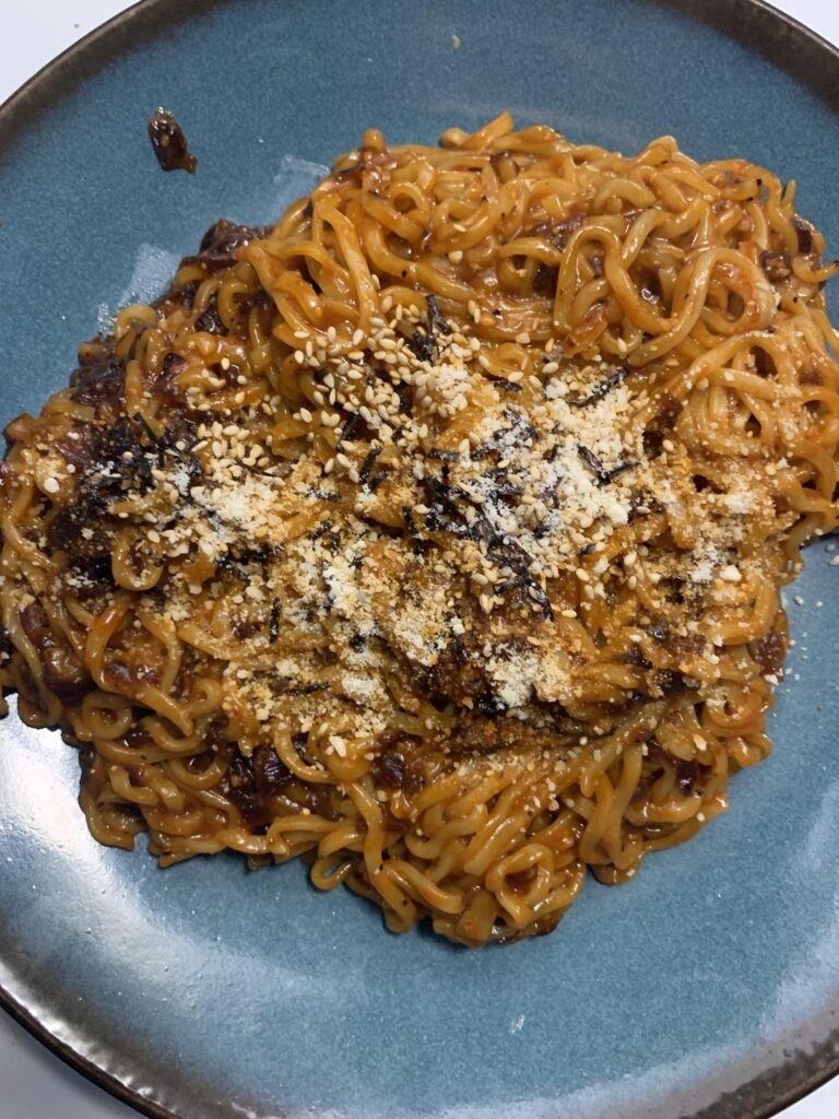 Carolina Reaper Buldak with some caramelized onions and parm. Not bad.