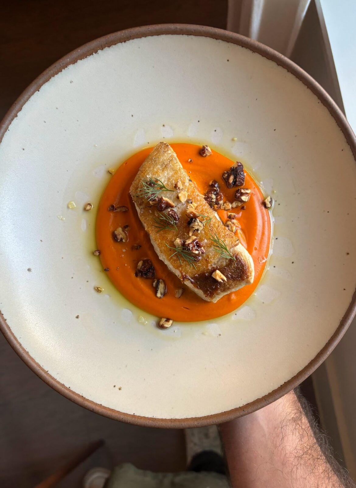 Pan seared Halibut over a honeynut squash, fennel, and guajillo puree. Topped with candied walnuts.