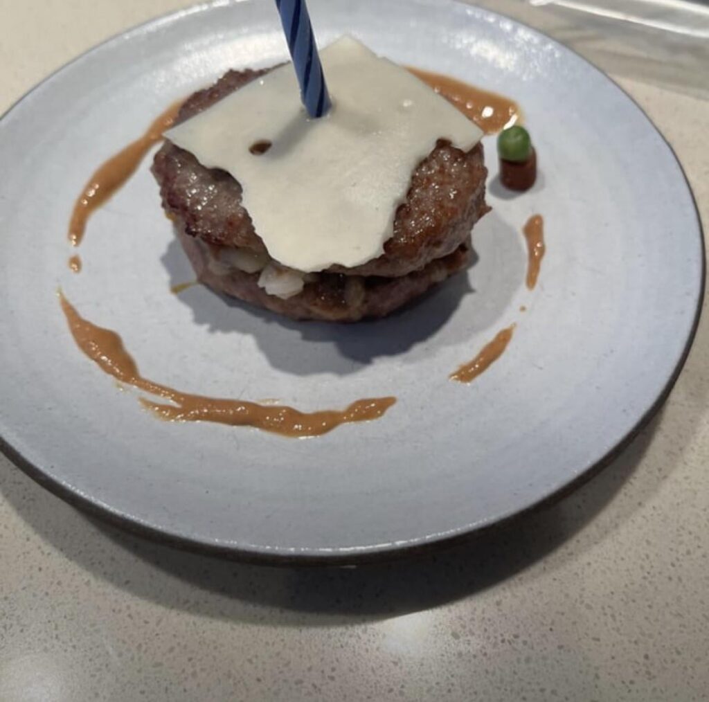 A lovely birthday cake for myself. Two patties with swiss cheese and a peanut butter glaze and alongside a single pea.