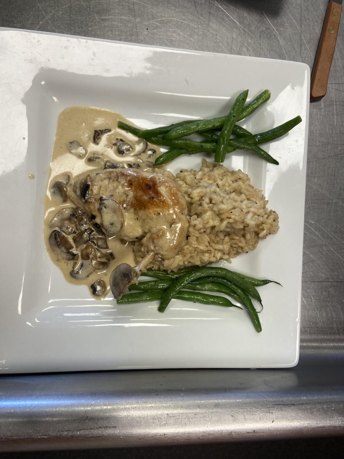 Sautéed French cut chicken breast with a mushroom sauce, chicken stock risotto, and green beans.